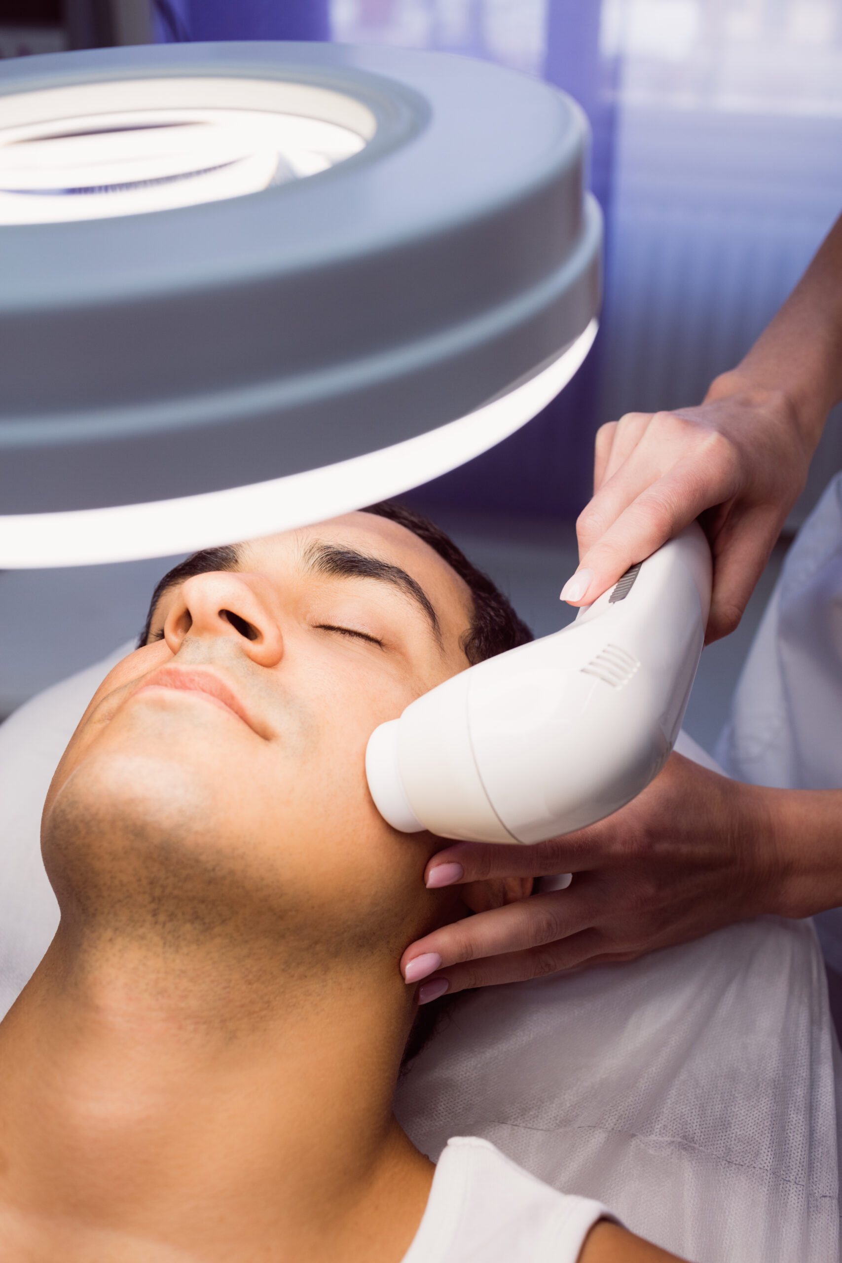 Man getting a facial massage for cosmetic treatment at clinic